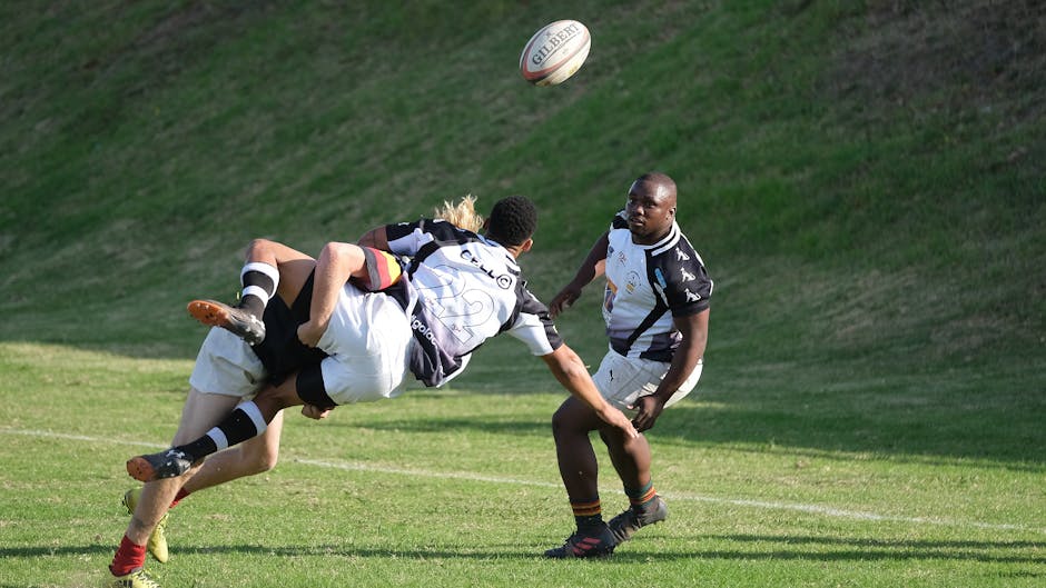 Intense rugby match in South Africa showcasing athletes tackling and competing outdoors.