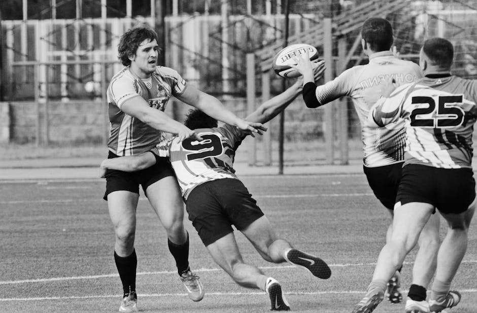 Dynamic black and white photo of rugby players in action during an intense match on the field.