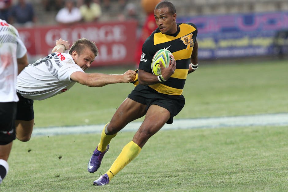 Rugby players competing in an intense outdoor match, showcasing agility and speed.
