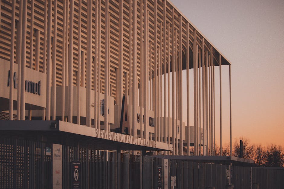 Modern architecture of Matmut Atlantique stadium with a vibrant sunset backdrop