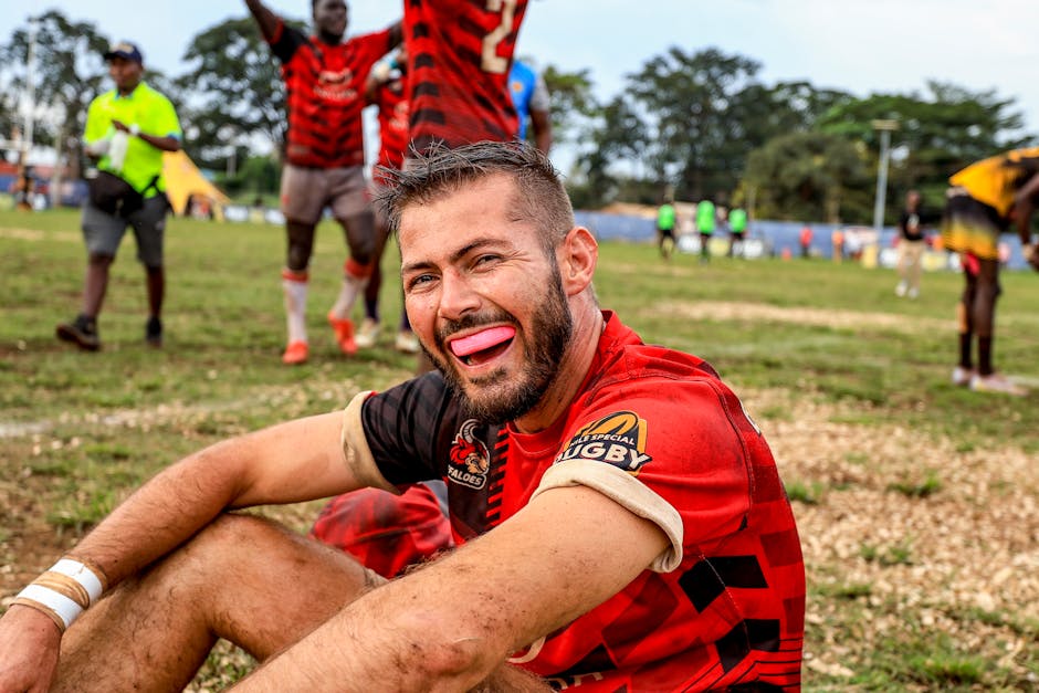 Energized rugby player celebrating after a match on a sunny outdoor field.