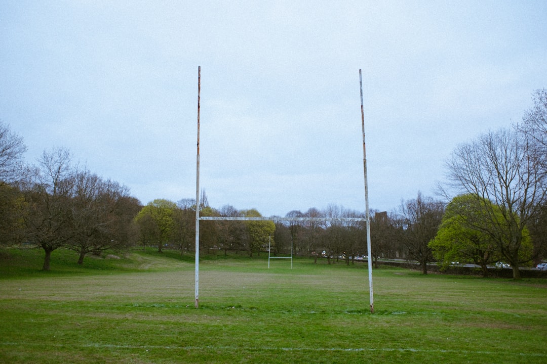 Rugby goal posts stand on a grassy field.