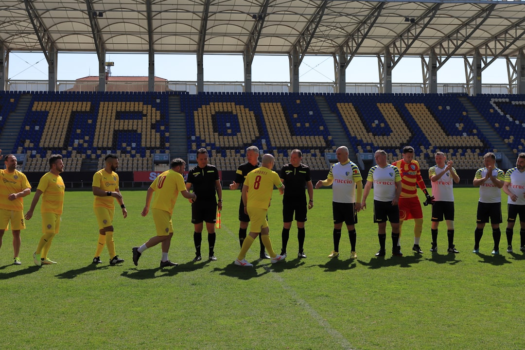 A group of men standing on top of a soccer field