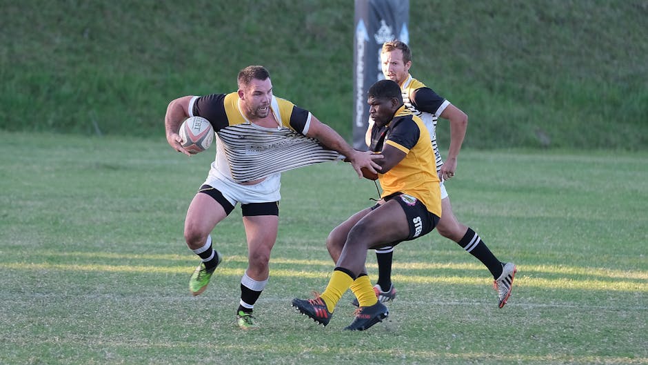 Intense rugby match in South Africa showcasing teamwork and competition on a sunny day.